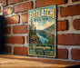 A vintage-style sign for Potlatch State Park, featuring a scenic landscape with a river and mountains, mounted on a brick wall.