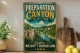 a vintage-style sign for Preparation Canyon State Park, with a scenic illustration of the canyon and a river. The sign encourages visitors to explore nature's hidden gem, Iowa.