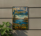 A vintage-style sign for Prineville Reservoir State Park, featuring a scenic landscape with a lake, mountains, and a boat.