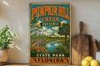 A vintage-style sign for Pumpkin Hill Creek Preserve in Florida, featuring a scenic illustration of a river, bridge, and surrounding landscape.