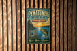 A vintage-style metal sign for Pennsylvania State Park, featuring a scenic image of a lake, trees, and a fish jumping out of the water.
