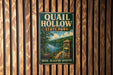 A vintage metal sign for Quail Hollow State Park in Ohio, featuring a scenic illustration of a forest and a lake.