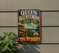 A vintage-style metal sign for Queen Wilhelmina State Park in Arkansas, featuring a scenic landscape with a cliff, flowers, and a cabin.