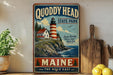 A vintage-style sign for Quoddy Head State Park in Maine, featuring a lighthouse and a coastal landscape.