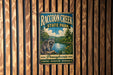 A vintage metal sign for Raccoon Creek State Park, featuring a raccoon and a scenic landscape, is displayed on a wooden wall.