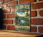 A vintage-style metal sign for Raccoon Creek State Park in Pennsylvania, featuring a raccoon and a scenic landscape.