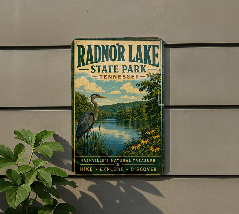 A vintage-style metal sign for Radnor Lake State Park in Tennessee, featuring a scenic illustration of a heron and a lake surrounded by trees and flowers.
