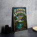 A vintage-style sign for Rainbow Springs State Park in Florida, featuring a tropical landscape with a rainbow, palm trees, and a body of water.