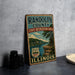A vintage metal sign for Randolph County, Illinois, featuring a scenic landscape with a river and trees.
