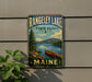 A vintage-style metal sign for Rangeley Lake State Park in Maine, featuring a scenic landscape with a lake, mountains, and a canoe.