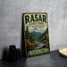 A vintage-style metal sign for "RASAR STATE PARK" in Washington, featuring a mountain landscape with a waterfall.