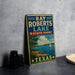 A vintage-style sign for Ray Roberts Lake, a state park in Texas, featuring a scenic illustration of a lake, trees, and a sailboat.