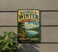 A vintage-style metal sign for Raymond B. Winter State Park in Pennsylvania, featuring a scenic landscape with a lake and mountains.