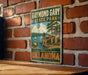 A vintage-style metal sign for Raymond Gary State Park in Oklahoma, featuring a scenic landscape with a lake and mountains.