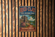 A vintage-style metal sign for Red Clay State Historic Park in Tennessee, featuring a wooden fence and a building with a tower.