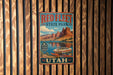 A vintage-style metal sign for Red Fleet State Park in Utah, featuring a scenic illustration of a boat on a lake surrounded by mountains.