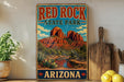 A vintage-style sign for Red Rock State Park in Arizona, featuring a desert landscape with red rock formations and a river.