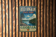 A vintage metal sign for Reed Bingham State Park in Georgia, featuring a scenic landscape with a lake and mountains.