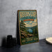 A vintage-style metal sign for Reeds Gap State Park in Pennsylvania, featuring a scenic mountain landscape with a river and pine trees.