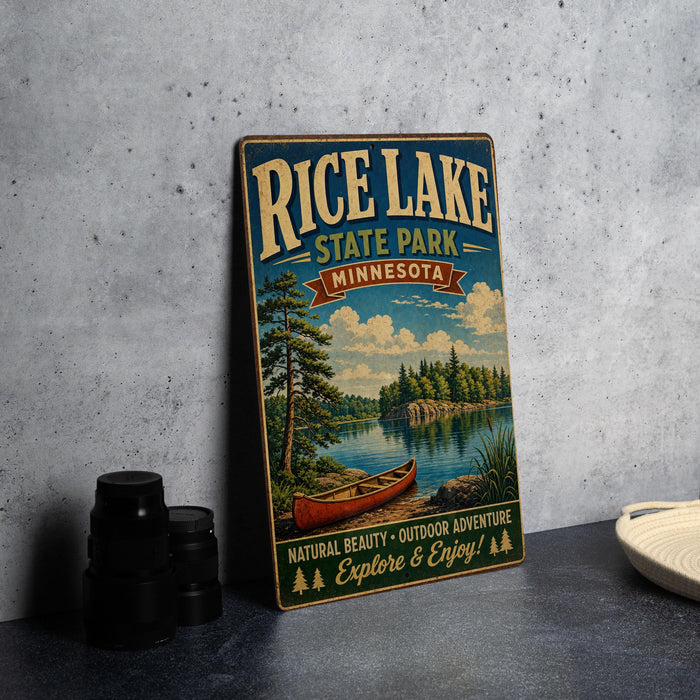 A vintage-style metal sign for Rice Lake State Park in Minnesota, featuring a scenic illustration of a lake, canoe, and forest.