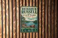 A vintage-style metal sign for Richard B. Russell State Park in Georgia, featuring a scenic illustration of a lake and mountains.