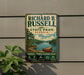 A vintage-style metal sign for Richard B. Russell State Park in Georgia, featuring a scenic image of a lake and mountains.