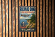 A vintage-style metal sign for the Richard Bong State Recreation Area in Wisconsin, featuring a propeller plane and a scenic landscape.