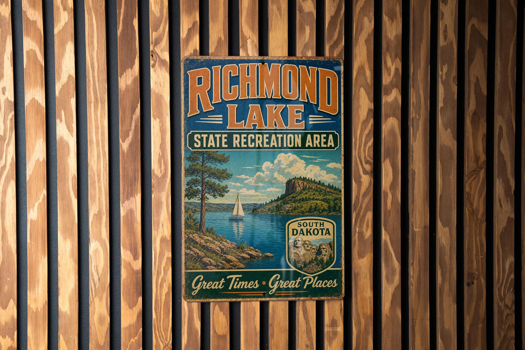 A vintage-style sign for Richmond Lake, a state recreation area in South Dakota, featuring a scenic landscape with a lake, mountains, and a sailboat.