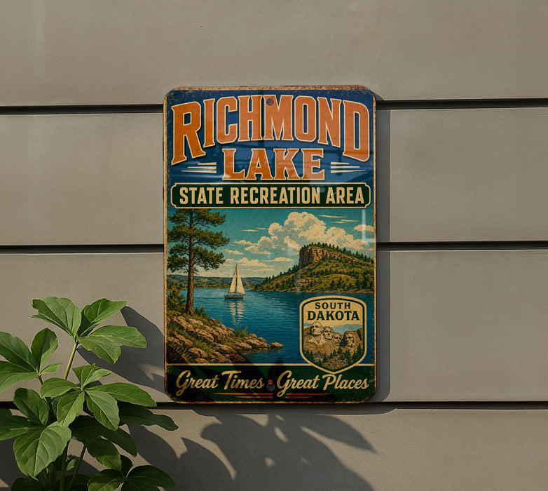 A vintage-style sign for Richmond Lake, a state recreation area in South Dakota, featuring a scenic landscape with a sailboat on the lake.