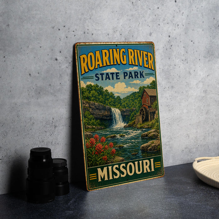 A vintage-style metal sign for Roaring River State Park in Missouri, featuring a scenic illustration of a waterfall and surrounding landscape.