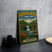 A vintage-style metal sign for Roaring River State Park in Missouri, featuring a scenic illustration of a waterfall and surrounding landscape.