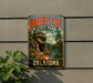 A vintage-style metal sign for Robbers Cave State Park in Oklahoma, featuring a scenic image of the cave and surrounding landscape.