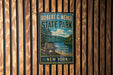 A vintage-style metal sign for Robert G. Wehle State Park in New York, featuring a scenic landscape with pine trees, a lake, and mountains.
