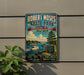 A vintage-style metal sign for Robert Moses State Park, New York, featuring a scenic image of a lake, boat, and surrounding landscape.
