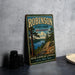 A vintage metal sign for Robinson State Park in Massachusetts, featuring a scenic landscape with pine trees and a lake.