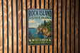 A vintage-style metal sign for Rock Island State Park in Wisconsin, featuring a scenic landscape with cliffs, water, and trees.