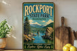 A vintage-style sign for Rockport State Park in Washington, featuring a scenic landscape with a bridge, mountains, and a river.