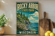 A vintage-style poster of Rocky Arbor State Park in Wisconsin, featuring a scenic landscape with pine trees, cliffs, and a body of water.