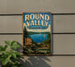 A vintage metal sign for the Round Valley Recreation Area in New Jersey, featuring a scenic image of a lake and mountains.