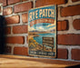 A vintage-style metal sign for Rye Patch, a State Recreation Area in Nevada, mounted on a brick wall.