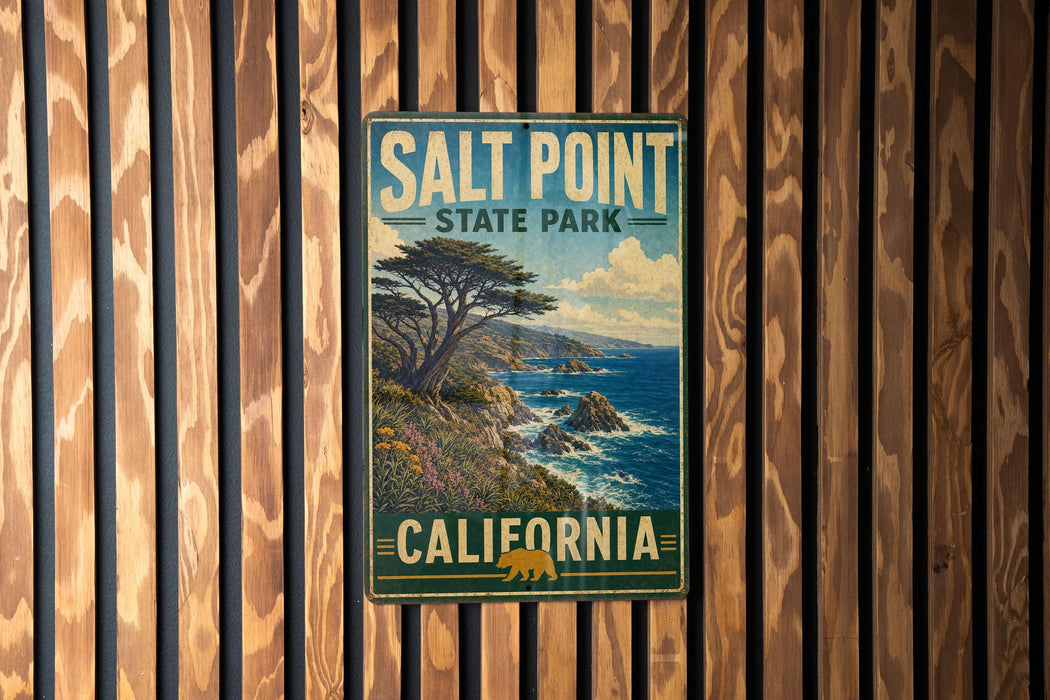 A vintage-style metal sign for Salt Point State Park in California, featuring a scenic landscape with a tree and ocean in the background.