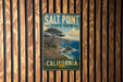 A vintage-style metal sign for Salt Point State Park in California, featuring a scenic landscape with a tree and ocean in the background.