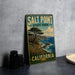 A vintage-style metal sign for Salt Point State Park in California, featuring a scenic landscape with a pine tree and ocean in the background.