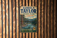 A vintage metal sign for Samuel P. Taylor State Park in California, featuring a scenic illustration of the Russian River and Redwood forests.