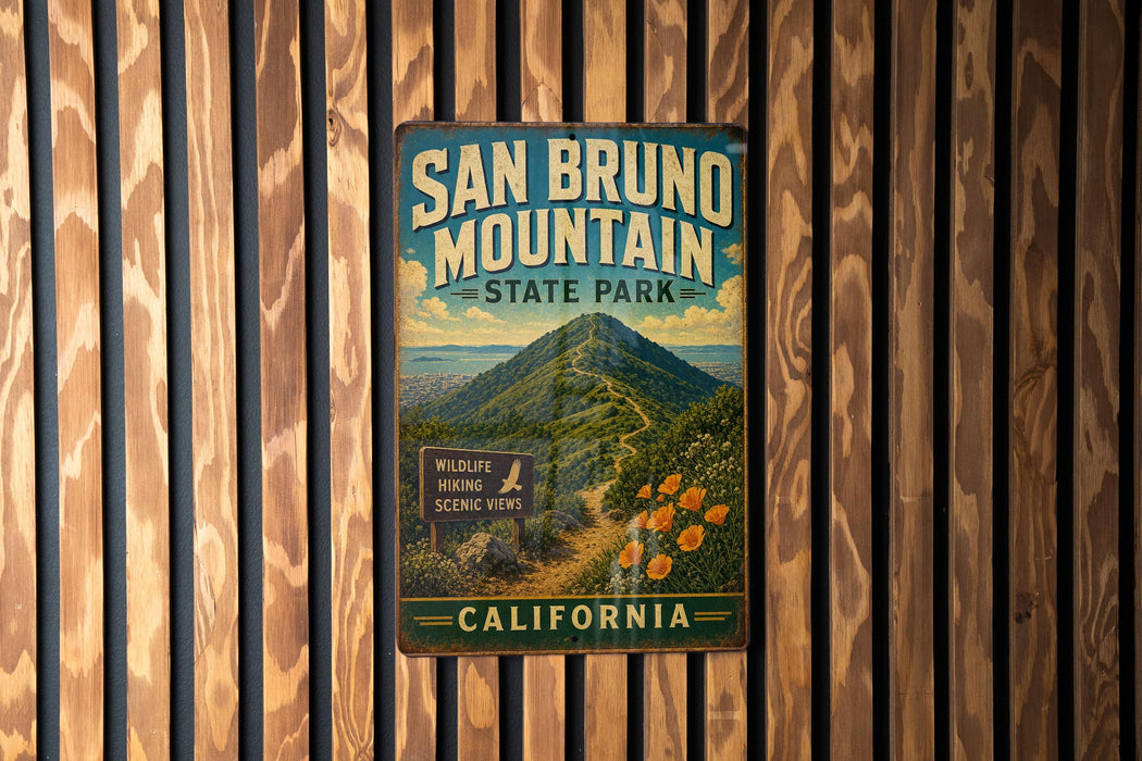 A vintage metal sign for San Bruno Mountain State Park in California, featuring a scenic mountain landscape with a trail leading to a wildlife viewing area.