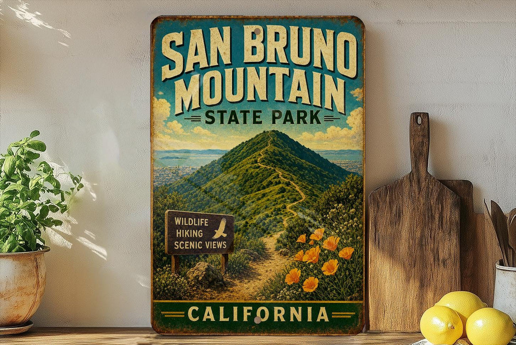 A vintage-style metal sign for San Bruno Mountain State Park in California, featuring a scenic mountain landscape with a trail leading to a wildlife viewing sign.