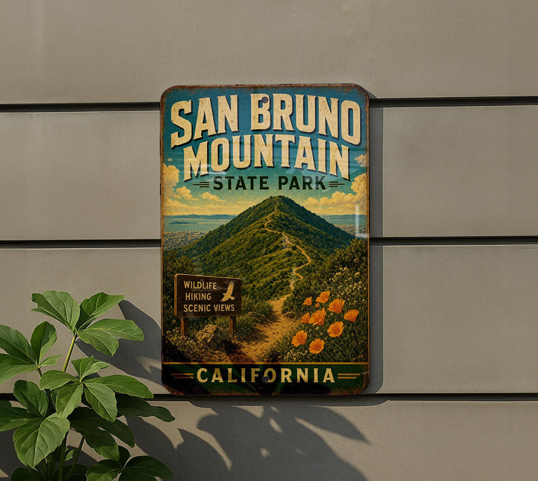 A vintage-style metal sign for San Bruno Mountain State Park in California, featuring a scenic mountain landscape with a trail and wildlife signs.
