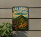 A vintage-style metal sign for San Bruno Mountain State Park in California, featuring a scenic mountain landscape with a trail and wildlife signs.