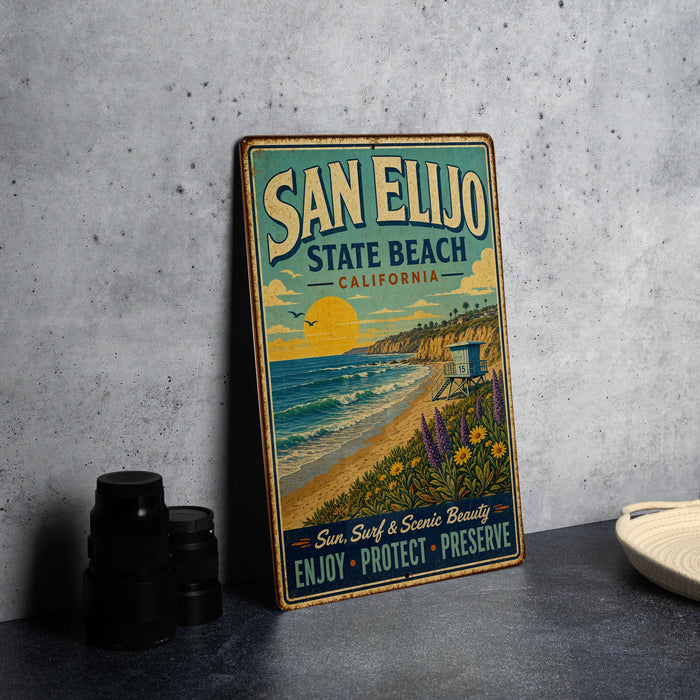 A vintage-style metal sign for San Elijo State Beach, California, featuring a beach scene with a sunset, palm trees, and a lifeguard tower.