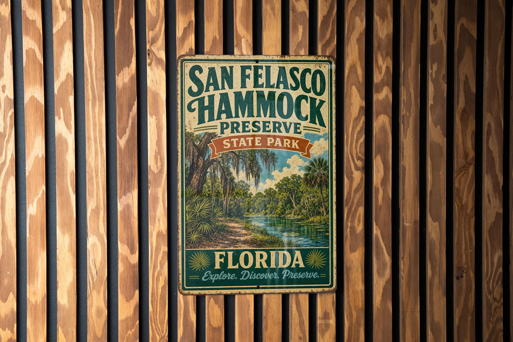 A vintage-style metal sign for San Felasco Hammock Preserve, featuring a tropical landscape with palm trees and a river.